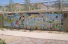 Full view of a 5x25 foot painted tile mural in a desert-friendly hospital courtyard