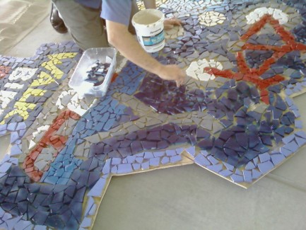 Roger's arm as he finishes a mosaic.