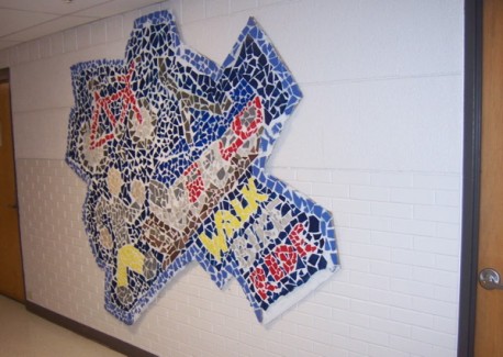 Mosaic of a person walking, a bicycle, and a light rail train
