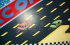 Cars race cross the mural
