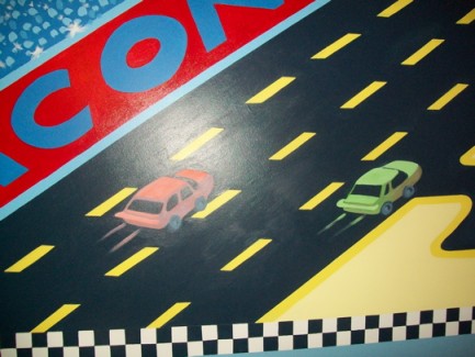 Cars race cross the mural