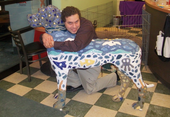 Artist Roger Whiting hug the dog