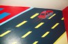 Close-up photo of road in this race track themed mural