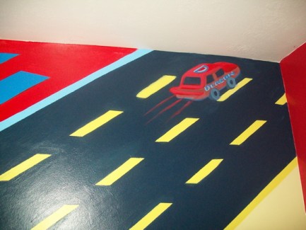 Close-up photo of road in this race track themed mural