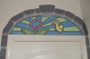 Faux stained glass window of a hummingbird and flower
