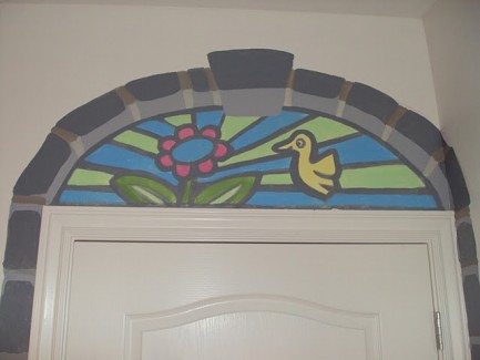 Faux stained glass window of a hummingbird and flower